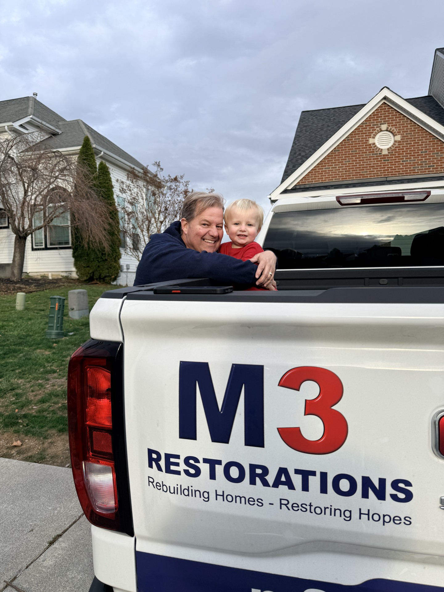 Tim Mihill with his grandson Timmy by the M3 Restorations truck